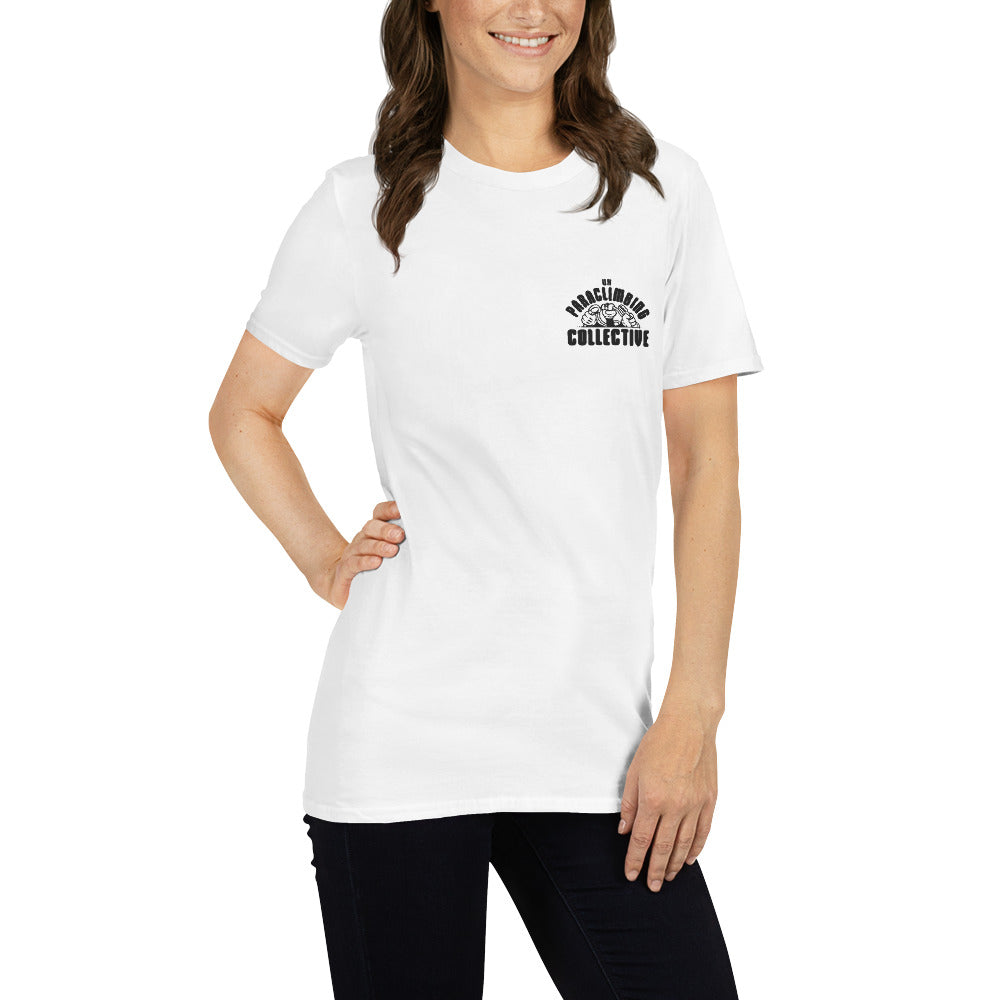 A white t-shirt with the black UK Paraclimbing Collective logo on the left breast. The logo is "UK paraclimbing collective" with hands holding climbing ropes and quickdraws